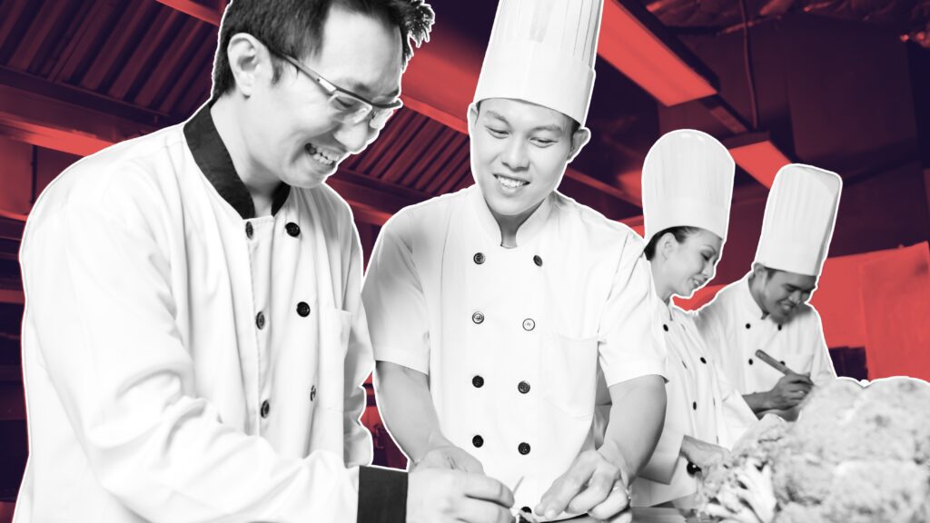 Chef preparing food in a busy kitchen with a supportive team atmosphere on how to attract and retain temporary kitchen staff