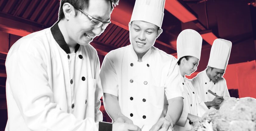 Chef preparing food in a busy kitchen with a supportive team atmosphere on how to attract and retain temporary kitchen staff