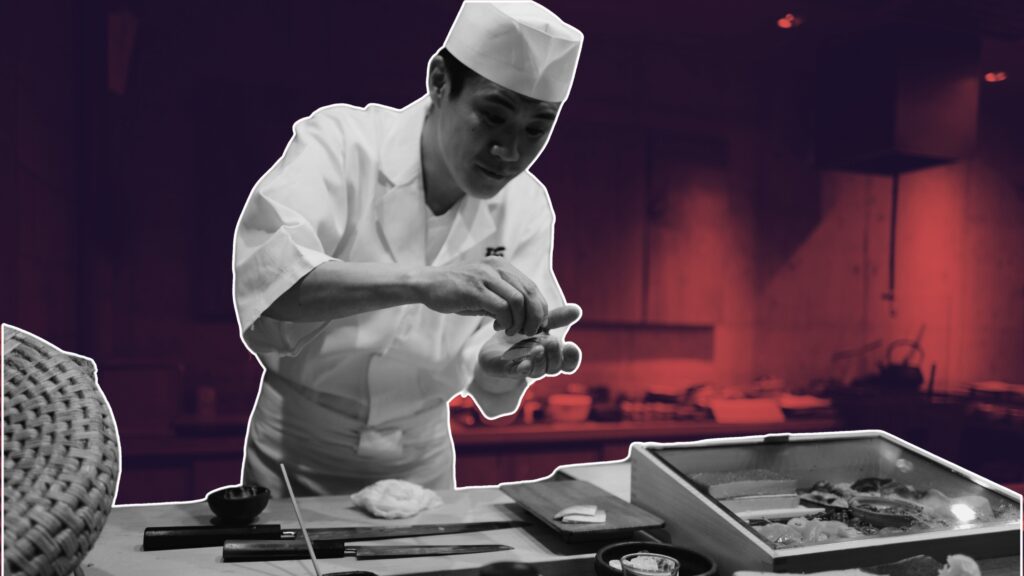 Chef marking waste log in busy prep area