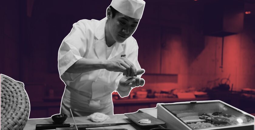 Chef marking waste log in busy prep area