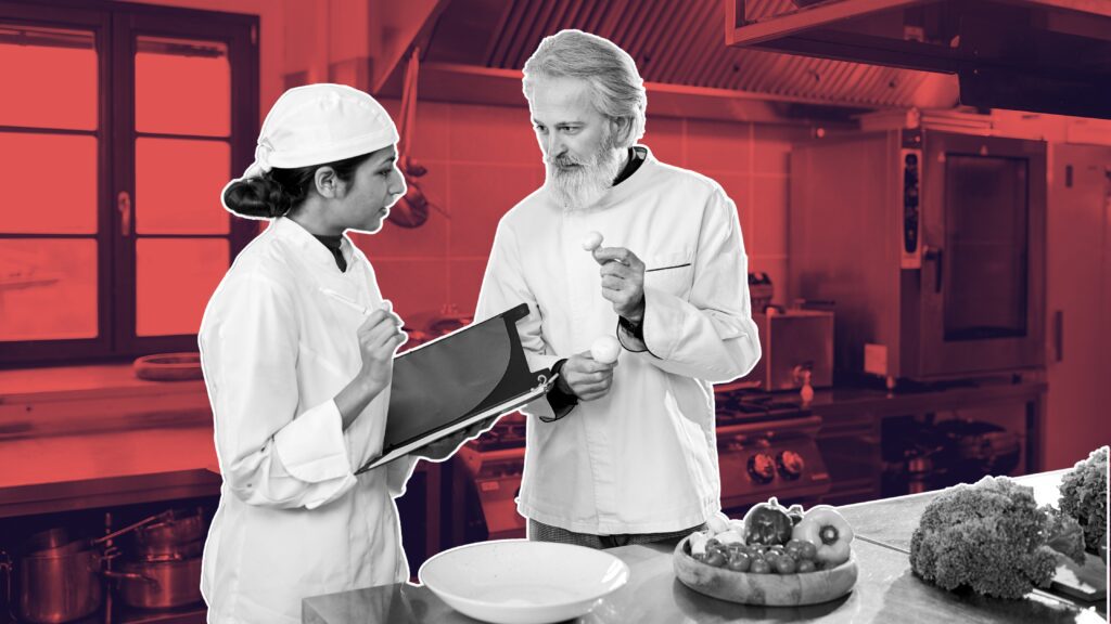 Young hospitality staff mentoring senior manager during a team meeting, reverse mentorship in hospitality