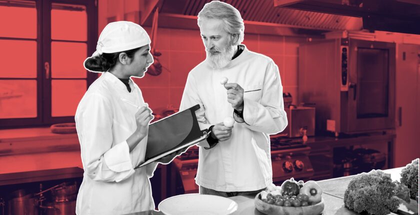 Young hospitality staff mentoring senior manager during a team meeting, reverse mentorship in hospitality