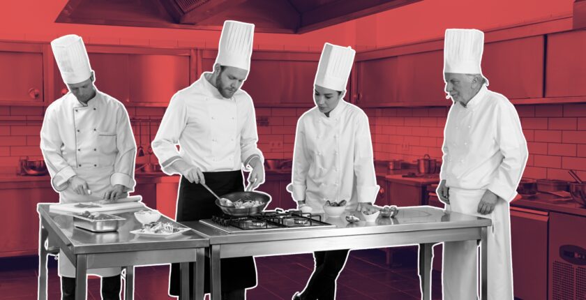 Printed kitchen role PDFs pinned on prep room wall