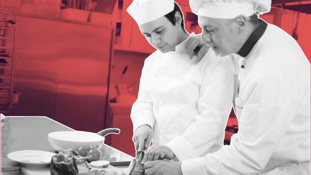 chef and waiter discussing specials and sales techniques workshops for hospitality teams