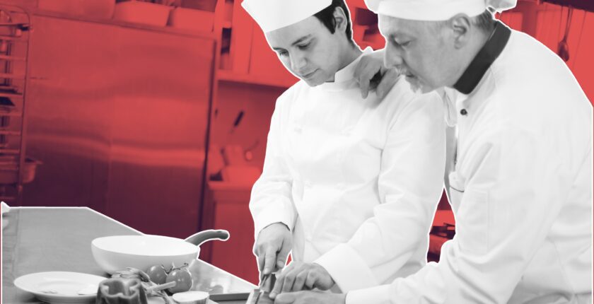 chef and waiter discussing specials and sales techniques workshops for hospitality teams