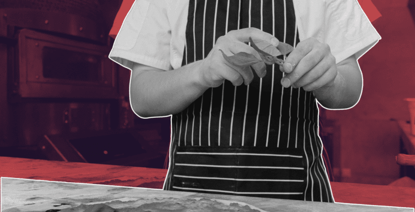 Chef reviewing digital tools with “Founder” badge on screen